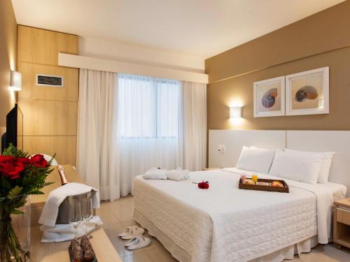 Ein Bett oder Betten in einem Zimmer der Unterkunft Mercure Camboriu