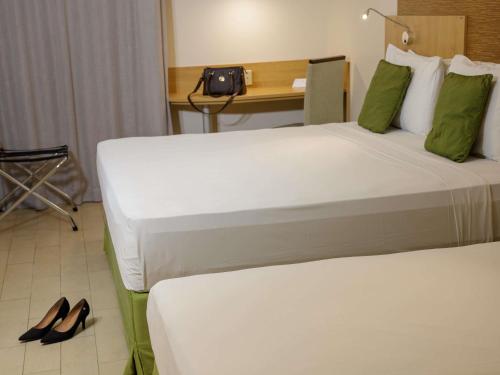 Кровать или кровати в номере Mercure Maceio Pajuçara