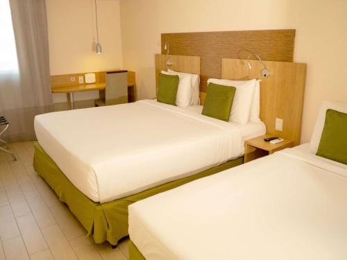 Кровать или кровати в номере Mercure Maceio Pajuçara