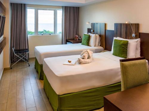 Кровать или кровати в номере Mercure Maceio Pajuçara