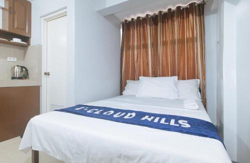 a bed in a small room with a window at V-Cloud Hills Boarding House Near NAIA Terminal in Manila