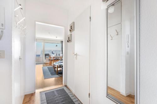 a hallway with a mirror and a dining room at Ferienwohnung Muschelbank No 4 in Büsum