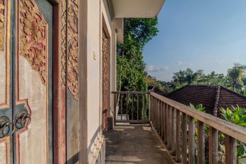 a stairway to a house with a balcony at The Kertha Ubud in Ubud