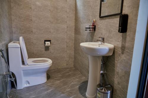a bathroom with a toilet and a sink at Samora River Lodge in Arusha