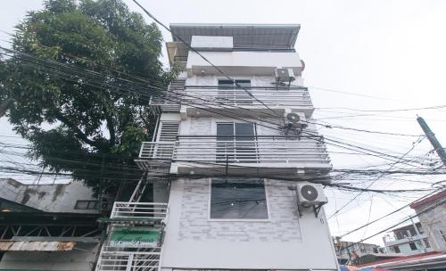 a tall white building with lots of power lines at V-Cloud Hills Boarding House Near NAIA Terminal in Manila