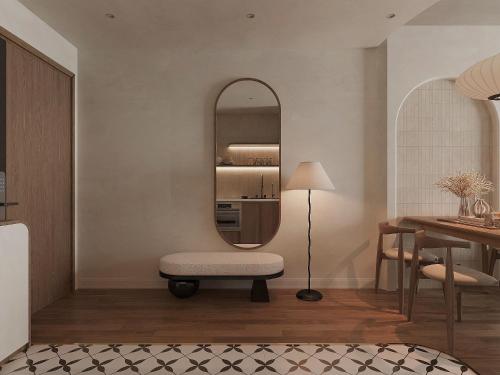 a living room with a chair and a mirror at SOHO Suites - Saigon Central, 5-Min-To-Bui Vien Street in Ho Chi Minh City