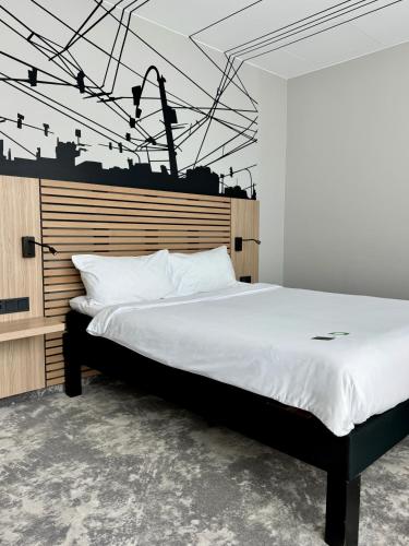 a bedroom with a large bed with white sheets at ibis Styles Warszawa City in Warsaw