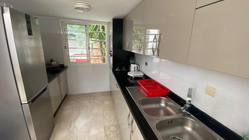 a kitchen with a sink and a counter top at spacieux villa avec terasse centre harhoura in Temara