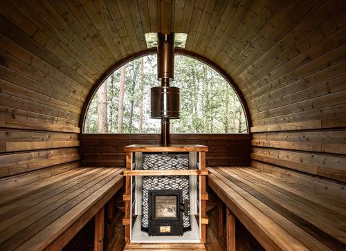 a room in a log cabin with a window at 1861 Châtel Hostel in Châtel