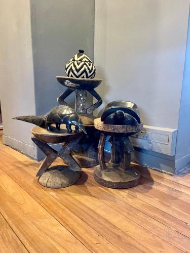 a group of hats sitting on top of a wooden floor at Piers Villa G in Harare