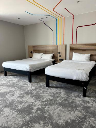 two beds in a room with two beds sidx sidx sidx sidx at ibis Styles Warszawa City in Warsaw
