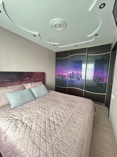 a bedroom with a large bed in a room at Good J&I apartment in Balvi