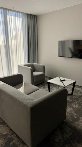a living room with a couch and two chairs and a table at ibis Styles Warszawa City in Warsaw