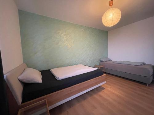 a small room with a bed and a couch at Skyline City Apartment in Berlin