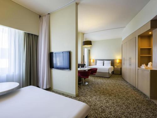 Postel nebo postele na pokoji v ubytování Novotel Suites Mall Avenue Dubai