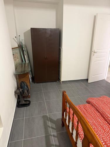 a bedroom with a bed and a cabinet in a room at Apartament de vacants centre-ville in Forcalquier