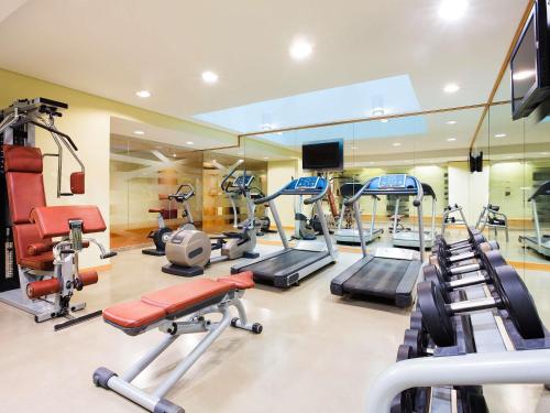 a gym with a bunch of treadmills and machines at ibis Dubai Al Rigga in Dubai