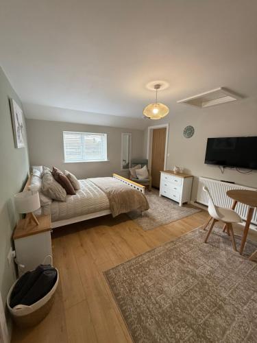 a living room with a bed and a table at The Annexe at Kirtonia in Lydford