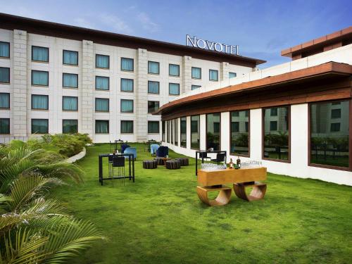 a hotel with a grass yard in front of a building at Novotel Hyderabad Airport in Hyderabad