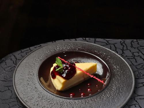a piece of cake on a plate on a table at Novotel Hyderabad Airport in Hyderabad