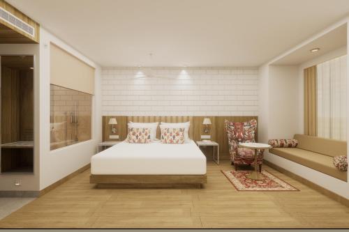 a bedroom with a white bed and a couch at Lemon Tree Premier, Tirupati in Tirupati