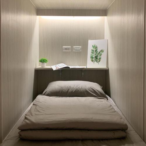 a bed in a room with a mirror at Lambay Island in Xiaoliuqiu