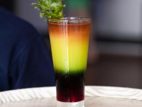a colorful drink sitting on top of a table at Ibis Lagos Airport in Ikeja
