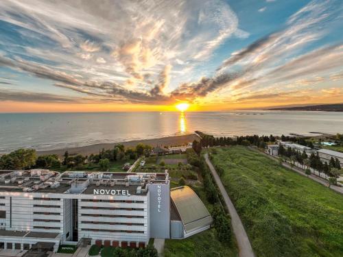 an aerial view of a resort with the sunset at Novotel Trabzon in Trabzon