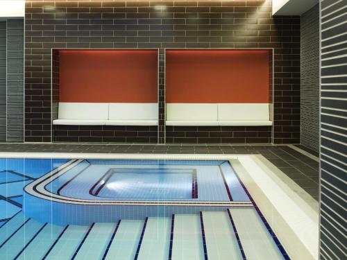 a swimming pool in the middle of a building at Novotel Trabzon in Trabzon