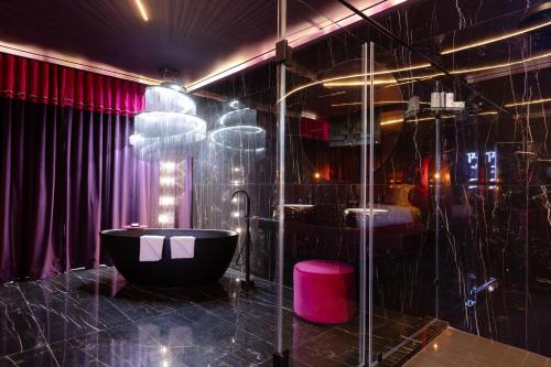 a black bathroom with a tub and a shower at Mint Hotel Rosebank in Johannesburg