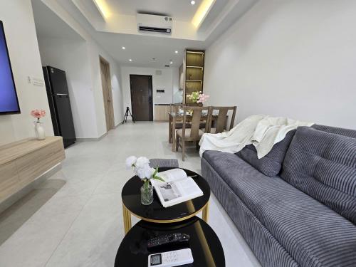 a living room with a couch and a table at SOHO Suites - Saigon Central, 5-Min-To-Bui Vien Street in Ho Chi Minh City