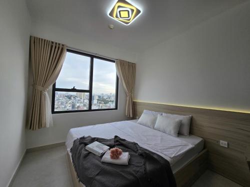 a bedroom with a bed with a teddy bear on it at SOHO Suites - Saigon Central, 5-Min-To-Bui Vien Street in Ho Chi Minh City