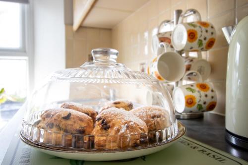 a glass dish filled with muffins on a counter at The Mariner, Westport in Westport