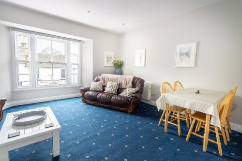 a living room with a couch and a table at The Mariner, Westport in Westport