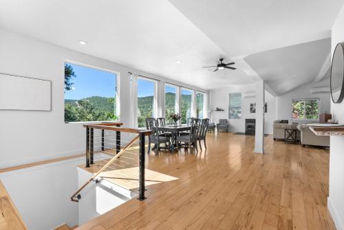 a dining room and living room with a table and chairs at Near Red Rocks with Hot Tub, Fire Pit and Views in Indian Hills