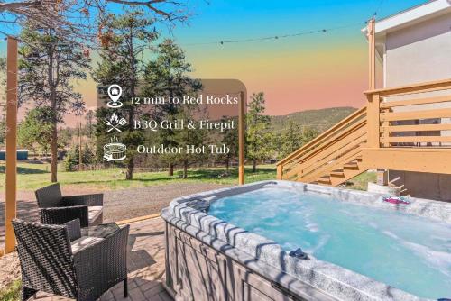 a swimming pool in a backyard with a hot tub at Near Red Rocks with Hot Tub, Fire Pit and Views in Indian Hills