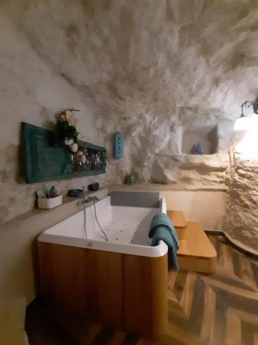 a bathroom with a bath tub with a sink at La luna nel pozzo in Gerace