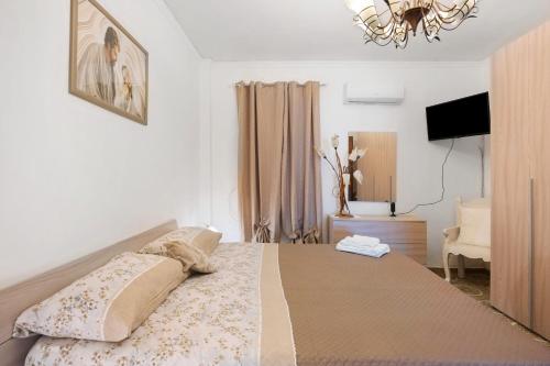 a bedroom with a bed and a chandelier at Holidayshouse in Ercolano