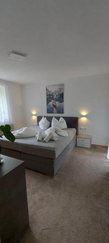 a bedroom with a bed with white sheets and pillows at Apartament Zaharia Ötztal in Tumpen