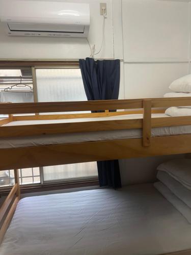Postel nebo postele na pokoji v ubytování 板橋 - 三国居Guest House