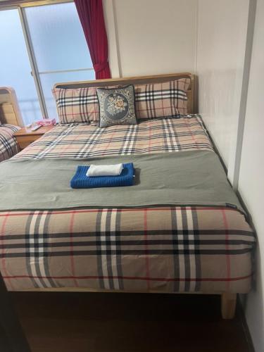Postel nebo postele na pokoji v ubytování 板橋 - 三国居Guest House