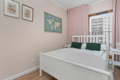 a bedroom with a white bed and a window at Large Apartment in Gdańsk with Gym, Parking and Air Conditioning by Noclegi Renters in Gdańsk