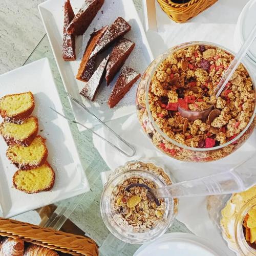 a table topped with different types of pastries and desserts at Poggio Piglia in Chiusi
