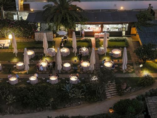 an overhead view of a restaurant with tables and umbrellas at Le Calette Bay in Cefalù