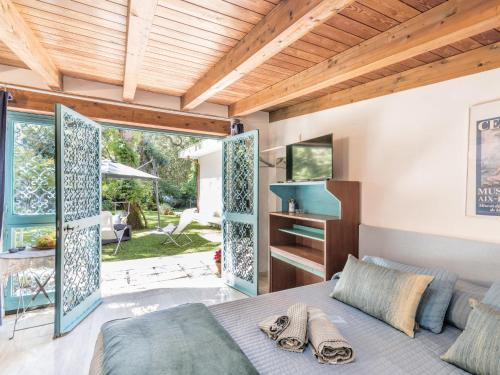 a bedroom with a bed and a large window at Holiday Home La casina nel bosco by Interhome in SantʼAlfonso