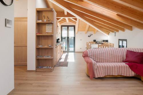 a living room with a couch and wooden ceilings at Sam Fiamet in Grosio