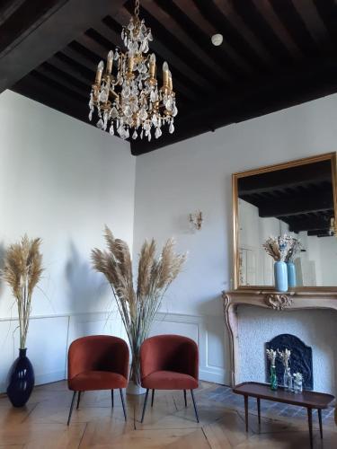 a living room with two chairs and a chandelier at Maison Philippe Le Bon Hôtel, Restaurant & Bar le 19 in Dijon