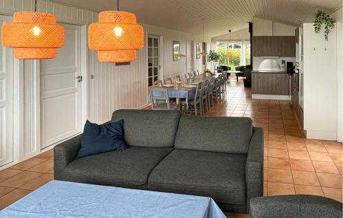 a living room with a couch and a dining room at Nice Home In Løkken With Kitchen in Løkken