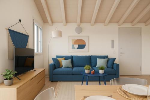a living room with a blue couch and a table at PENTHOUSE ISEO LAKE VIEW - Free Wi-Fi and Private Parking Included in Sale Marasino