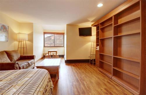 a bedroom with a bed and a couch and a tv at VS553 Village Square Hotel Room Hotel Room in Wheeler Junction
